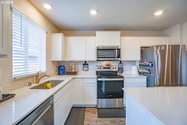 2804 N 3rd Way, Ridgefield, WA 98642 - kitchen with appliances with stainless steel finishes, a sink, white cabinets, light countertops, and recessed lighting
