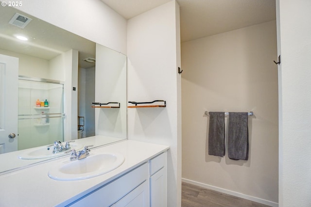 2804 N 3rd Way, Ridgefield, WA 98642 - bathroom featuring wood finished floors, vanity, baseboards, and a shower with door