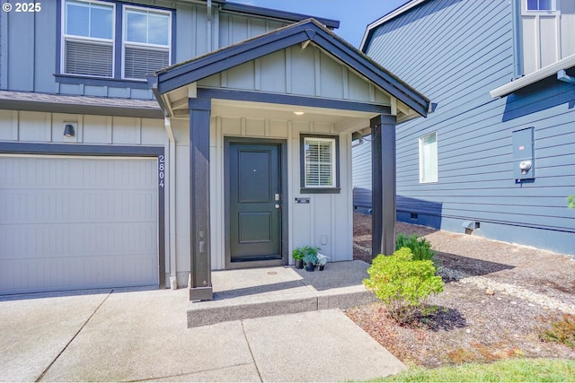 2804 N 3rd Way, Ridgefield, WA 98642 - view of exterior entry with board and batten siding, concrete driveway, and an attached garage
