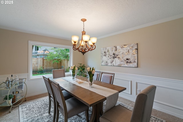 14230 Amberwood Cir, Lake Oswego, OR 97035 - carpeted dining area featuring a chandelier, a textured ceiling, a wainscoted wall, and ornamental molding