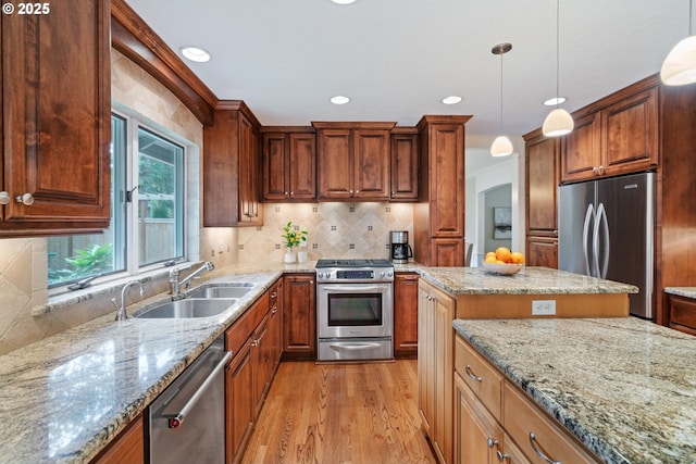 14230 Amberwood Cir, Lake Oswego, OR 97035 - kitchen featuring stainless steel appliances, a sink, light wood-style flooring, light stone counters, and recessed lighting