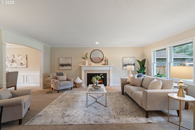14230 Amberwood Cir, Lake Oswego, OR 97035 - living room with carpet, a lit fireplace, crown molding, arched walkways, and a decorative wall