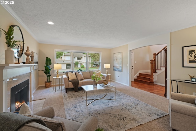 14230 Amberwood Cir, Lake Oswego, OR 97035 - living area with carpet, a textured ceiling, stairs, ornamental molding, and a premium fireplace