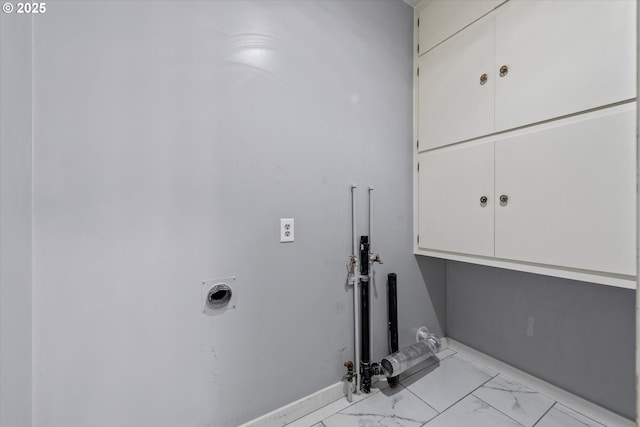 laundry area with cabinet space, baseboards, marble finish floor, and electric dryer hookup