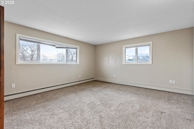 spare room featuring carpet floors and a baseboard heating unit