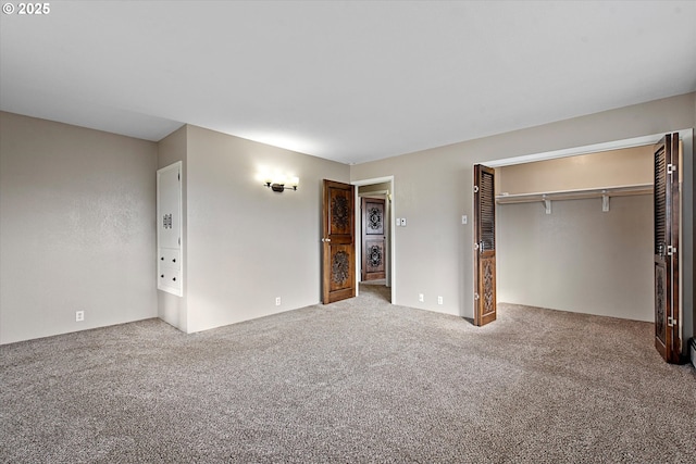 unfurnished bedroom with a closet and carpet flooring