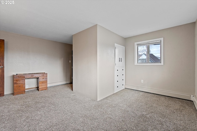 unfurnished bedroom featuring carpet floors and baseboard heating