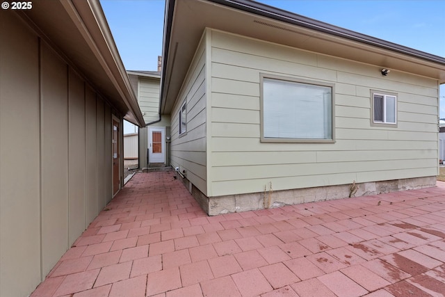 view of side of home with a patio area