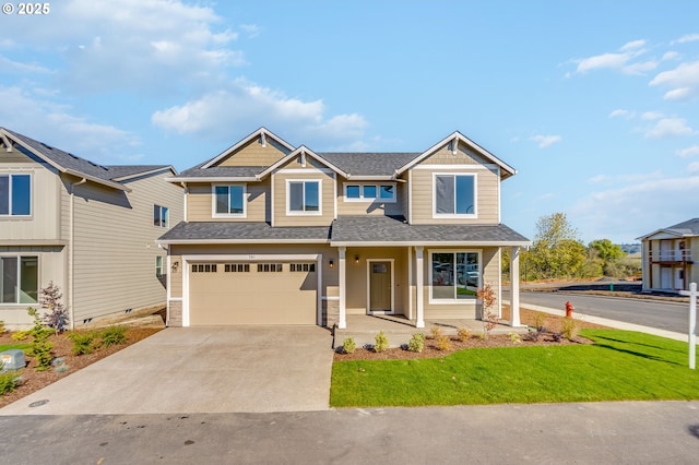 craftsman-style home featuring a front yard, covered porch, and a garage