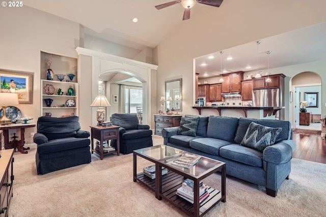 1114 S 6th Way, Ridgefield, WA 98642 - living area featuring arched walkways, ceiling fan, recessed lighting, high vaulted ceiling, and light carpet