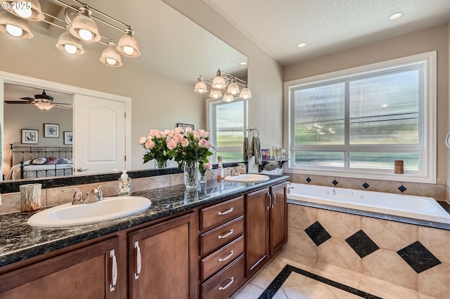 1114 S 6th Way, Ridgefield, WA 98642 - full bathroom featuring tile patterned flooring, double vanity, inlaid floor details, tiled bath, and ceiling fan