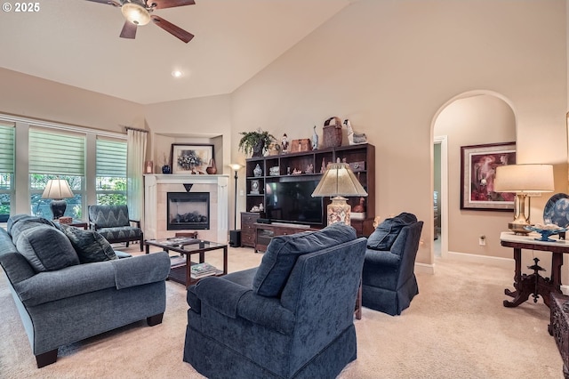1114 S 6th Way, Ridgefield, WA 98642 - living area featuring light colored carpet, ceiling fan, a tile fireplace, baseboards, and arched walkways