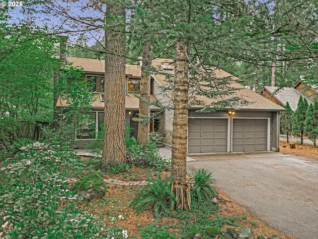 65277 E Sandy River Ln, Rhododendron, OR 97049 - view of front of property with asphalt driveway, roof with shingles, and a garage