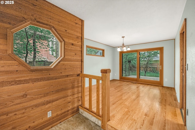 65277 E Sandy River Ln, Rhododendron, OR 97049 - hall featuring plenty of natural light, a chandelier, wooden walls, and wood finished floors