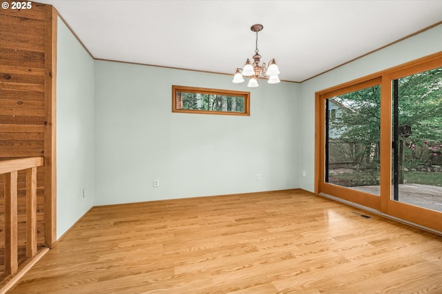 65277 E Sandy River Ln, Rhododendron, OR 97049 - unfurnished room featuring plenty of natural light, a chandelier, light wood finished floors, and crown molding