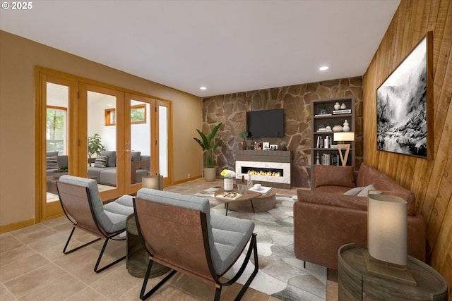65277 E Sandy River Ln, Rhododendron, OR 97049 - living room with french doors, an accent wall, a stone fireplace, baseboards, and recessed lighting