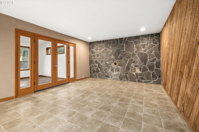 65277 E Sandy River Ln, Rhododendron, OR 97049 - empty room featuring french doors, an accent wall, wooden walls, and recessed lighting