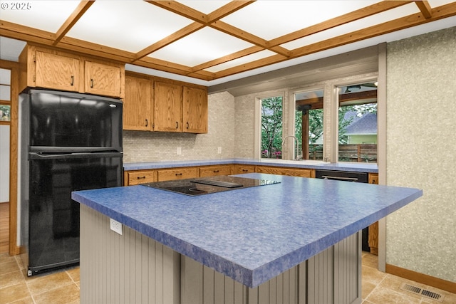 65277 E Sandy River Ln, Rhododendron, OR 97049 - kitchen with black appliances, coffered ceiling, brown cabinetry, dark countertops, and a kitchen island