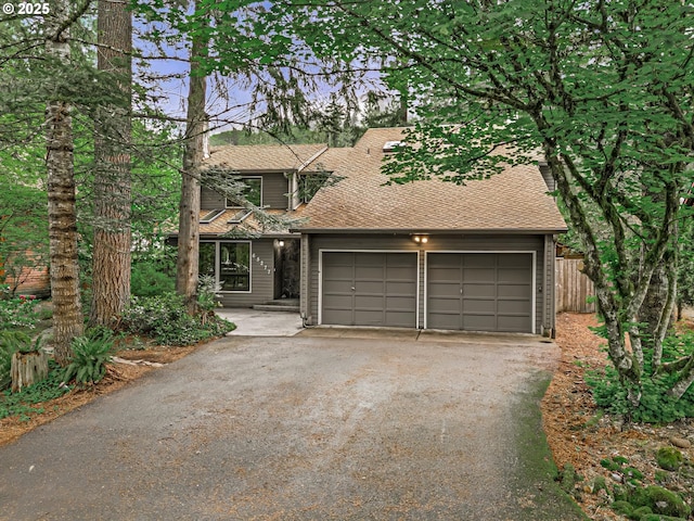 65277 E Sandy River Ln, Rhododendron, OR 97049 - view of front of home featuring asphalt driveway, a garage, and roof with shingles