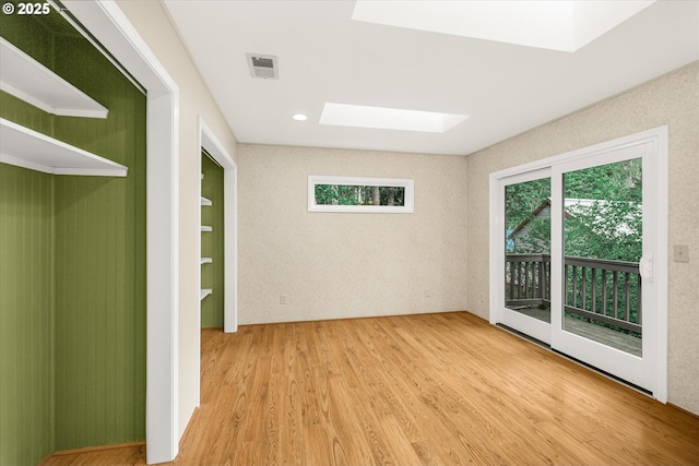 65277 E Sandy River Ln, Rhododendron, OR 97049 - empty room with a skylight, plenty of natural light, and wood finished floors