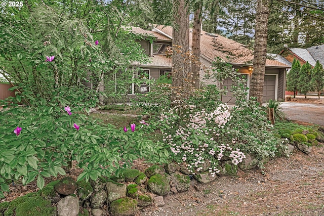 65277 E Sandy River Ln, Rhododendron, OR 97049 - view of side of home featuring asphalt driveway and a garage