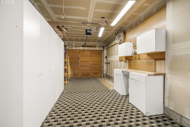 65277 E Sandy River Ln, Rhododendron, OR 97049 - garage featuring a garage door opener and refrigerator