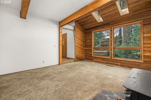 65277 E Sandy River Ln, Rhododendron, OR 97049 - unfurnished living room with wooden walls, a skylight, and carpet