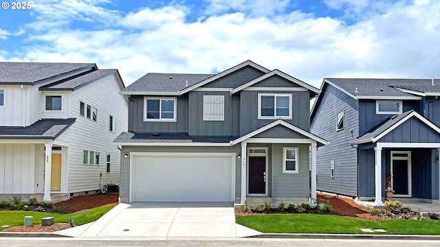 974 Legacy Ln, Eugene, OR 97402 - view of front facade featuring driveway, a garage, and board and batten siding