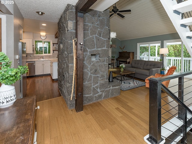 1339 NW 7th Ave, Camas, WA 98607 - living room featuring dark wood-style flooring, a ceiling fan, vaulted ceiling, and stairway