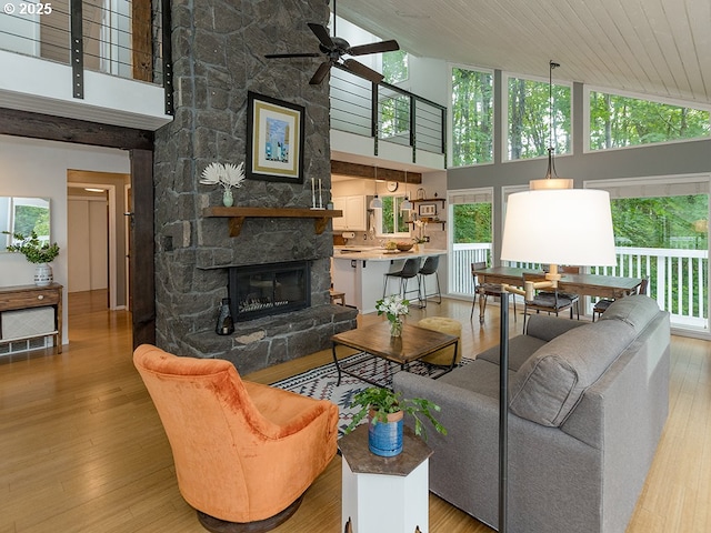 1339 NW 7th Ave, Camas, WA 98607 - living area with a towering ceiling, a ceiling fan, a stone fireplace, wood finished floors, and wood ceiling