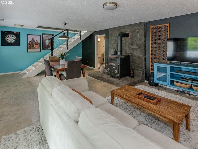 1339 NW 7th Ave, Camas, WA 98607 - living room with stairway, a wood stove, a textured ceiling, and baseboards