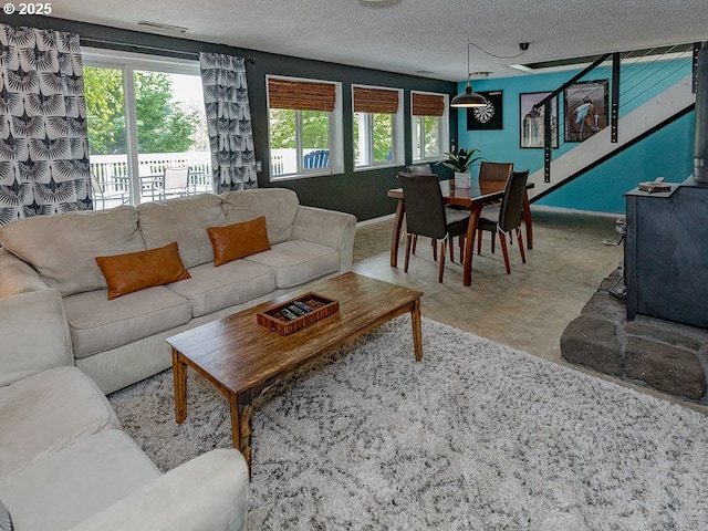 1339 NW 7th Ave, Camas, WA 98607 - living room featuring a wood stove, a textured ceiling, and baseboards