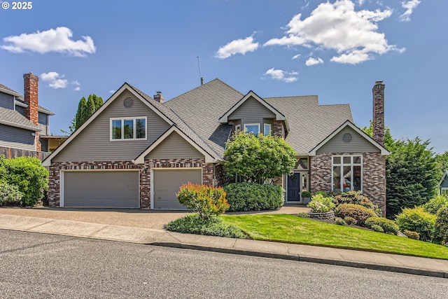 9122 NW Wood Rose Loop, Portland, OR 97229 - view of front of home featuring brick siding, an attached garage, concrete driveway, a chimney, and a front lawn