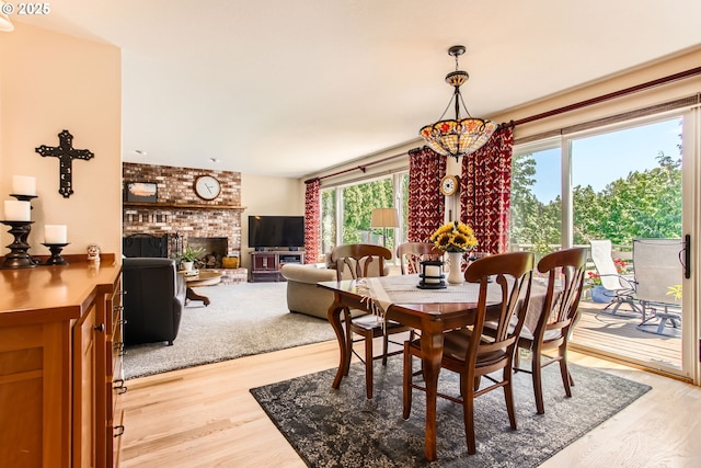 9122 NW Wood Rose Loop, Portland, OR 97229 - dining area featuring light wood-style flooring and a fireplace