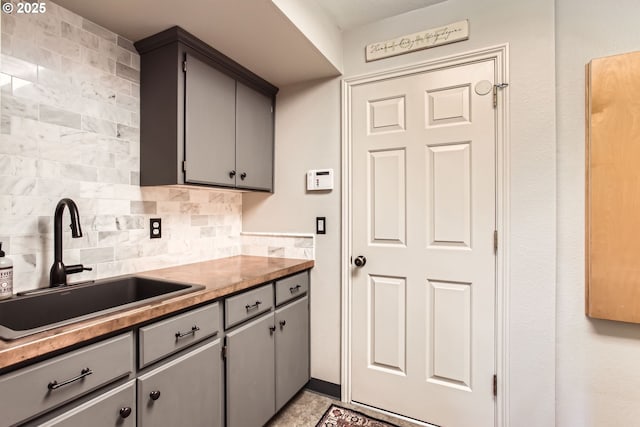 9122 NW Wood Rose Loop, Portland, OR 97229 - kitchen featuring gray cabinets, a sink, and decorative backsplash