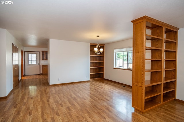 128 NW Woodrose Ct, Roseburg, OR 97471 - unfurnished room with light wood finished floors and a chandelier