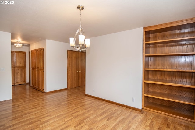 128 NW Woodrose Ct, Roseburg, OR 97471 - unfurnished room featuring a chandelier and light wood-style flooring