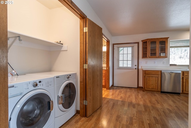 128 NW Woodrose Ct, Roseburg, OR 97471 - laundry room with washer and clothes dryer, wood finished floors, and healthy amount of natural light