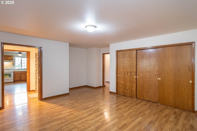 128 NW Woodrose Ct, Roseburg, OR 97471 - unfurnished bedroom with light wood-style floors and a closet