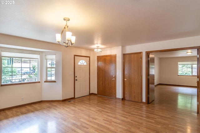 128 NW Woodrose Ct, Roseburg, OR 97471 - foyer entrance with light wood-style flooring and a chandelier