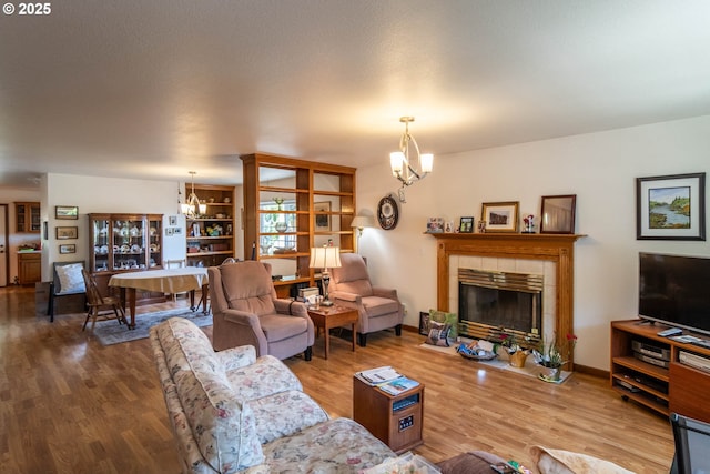 128 NW Woodrose Ct, Roseburg, OR 97471 - living room with a chandelier, wood finished floors, and a fireplace