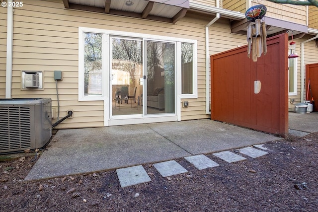 entrance to property with a patio and cooling unit