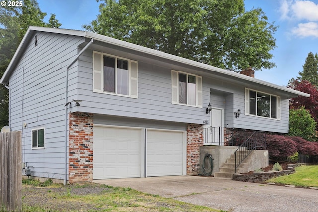 4433 SW 201st Ave, Beaverton, OR 97078 - split foyer home with a garage, brick siding, a chimney, and driveway