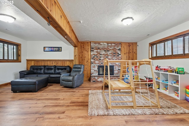 4433 SW 201st Ave, Beaverton, OR 97078 - playroom featuring a textured ceiling, wood finished floors, and wooden walls