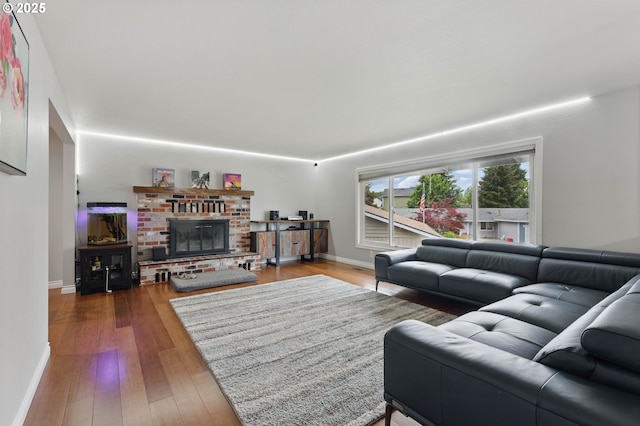 4433 SW 201st Ave, Beaverton, OR 97078 - living area with a fireplace, baseboards, and wood finished floors