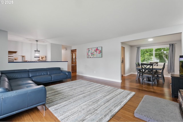 4433 SW 201st Ave, Beaverton, OR 97078 - living room featuring wood finished floors, a chandelier, and baseboards