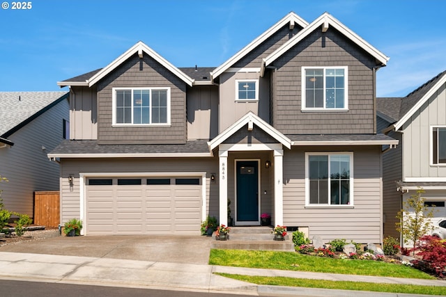 craftsman-style house featuring a garage, fence, roof with shingles, board and batten siding, and concrete driveway