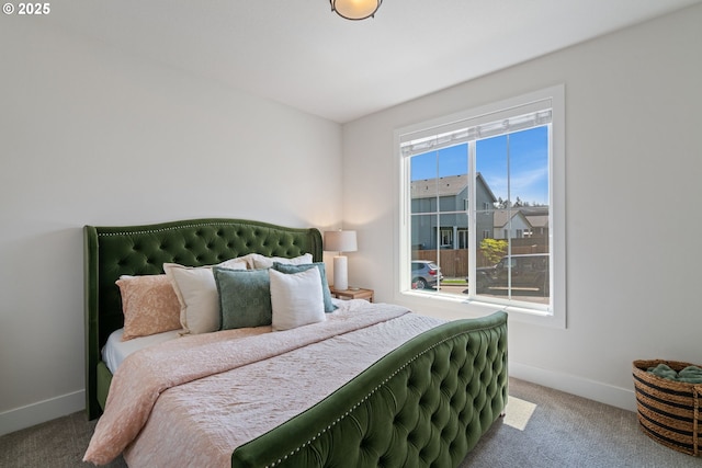 bedroom featuring carpet floors and baseboards