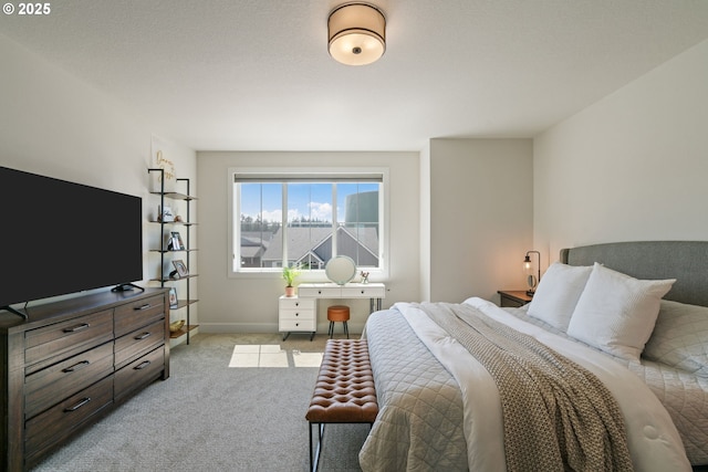 bedroom with baseboards and carpet flooring