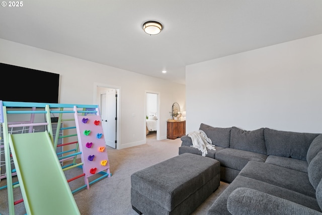 living room with recessed lighting, baseboards, and carpet